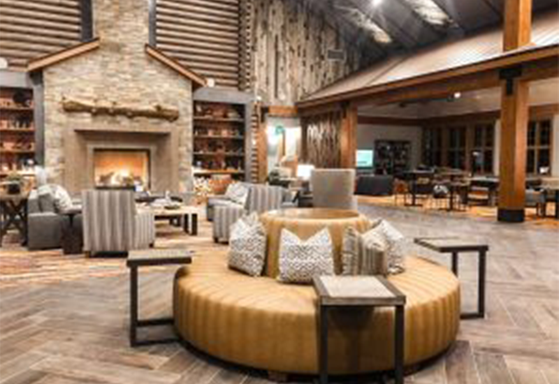 Cozy lobby with couches, chairs, and fire place