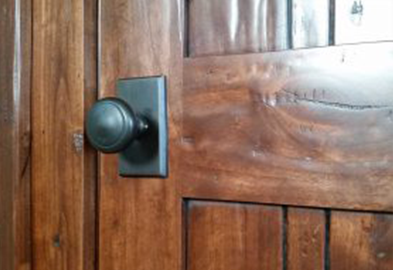 close up of door knob on wooden door